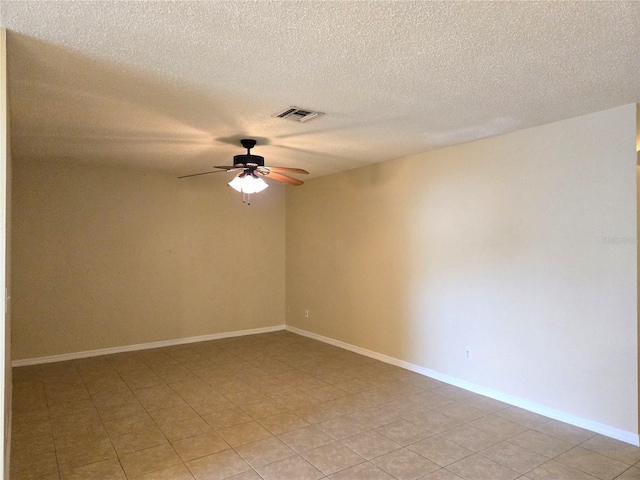 unfurnished room featuring ceiling fan and a textured ceiling