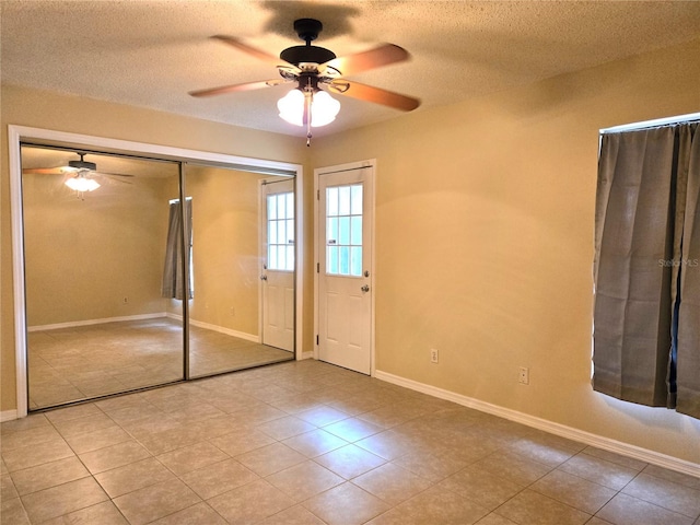 interior space featuring ceiling fan and a textured ceiling