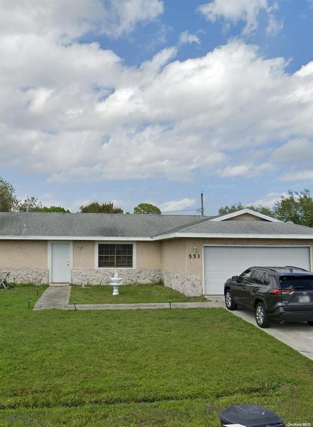 single story home featuring a front yard and a garage