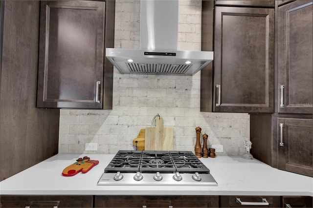 kitchen featuring dark brown cabinets, stainless steel gas cooktop, and wall chimney exhaust hood