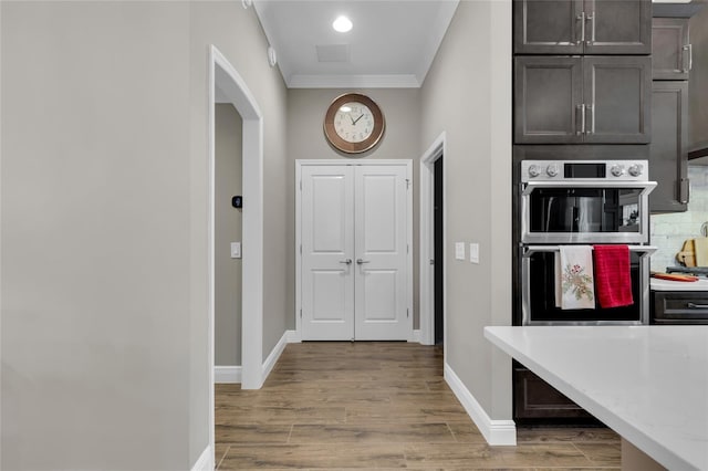 interior space with hardwood / wood-style floors and crown molding