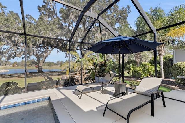 view of patio / terrace with a water view and glass enclosure