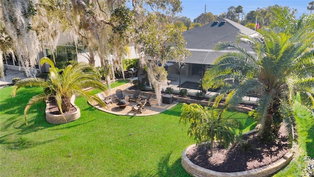 view of yard with glass enclosure and a patio