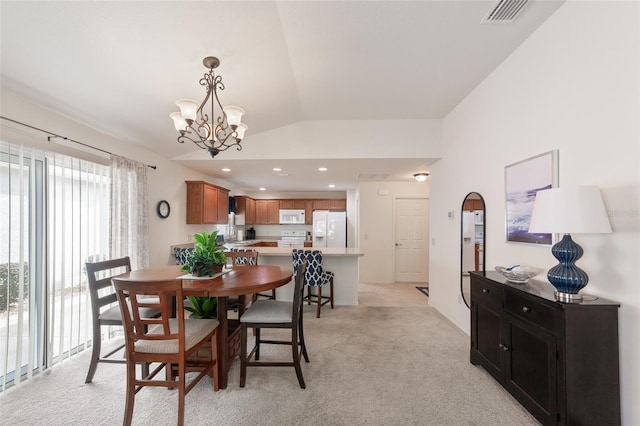 dining space featuring light colored carpet, vaulted ceiling, and a notable chandelier