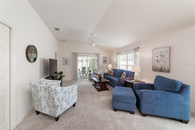 carpeted living room with ceiling fan and lofted ceiling