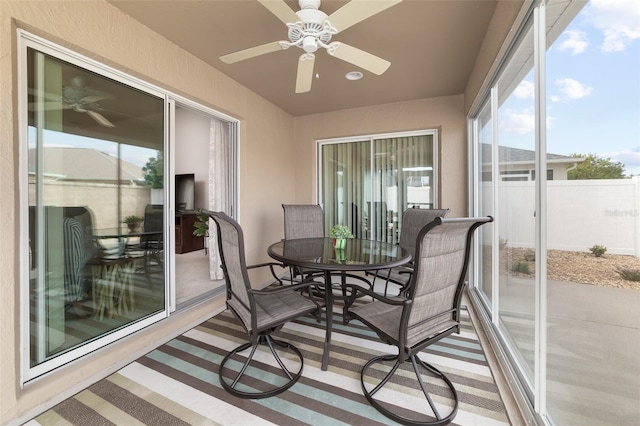 sunroom featuring ceiling fan