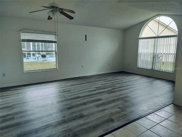 empty room featuring ceiling fan, wood-type flooring, and a textured ceiling