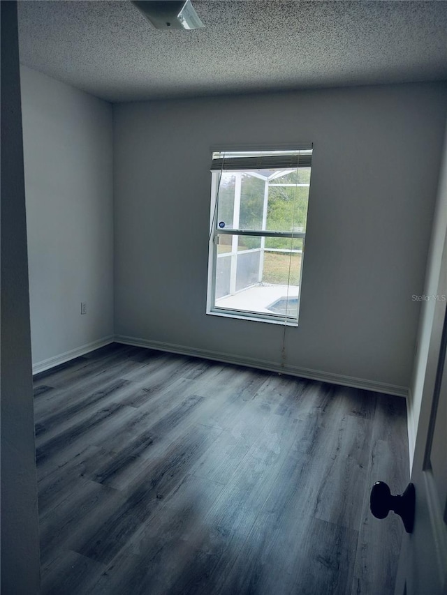 empty room featuring hardwood / wood-style floors and a textured ceiling