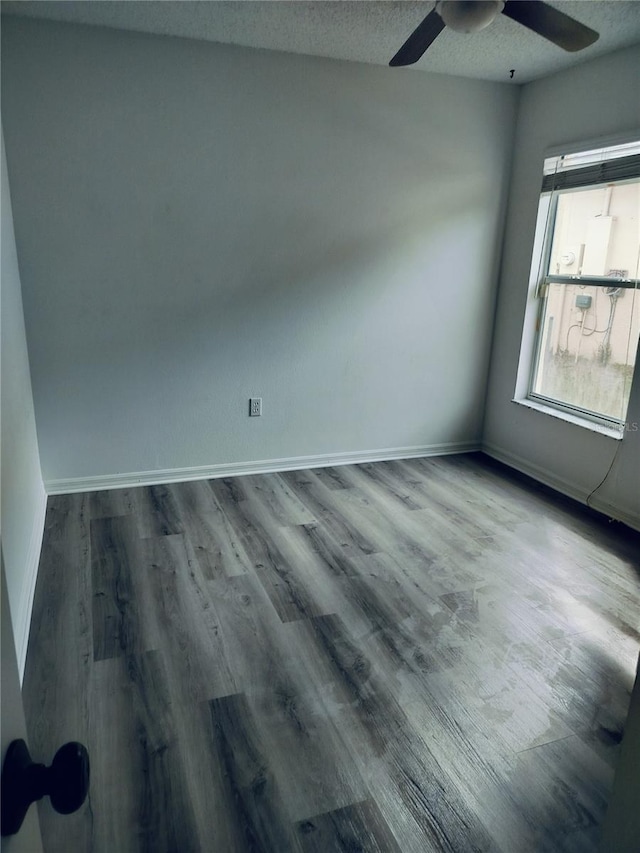 unfurnished room with hardwood / wood-style flooring, ceiling fan, and a textured ceiling