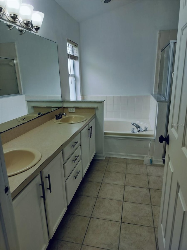 bathroom featuring tile patterned flooring, vanity, independent shower and bath, and a notable chandelier