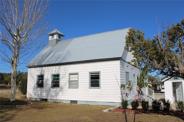 view of property exterior with a shed and a yard