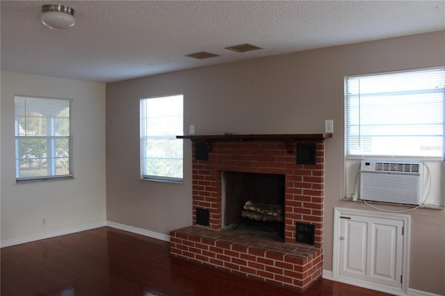 unfurnished living room featuring a fireplace, wood-type flooring, and a textured ceiling