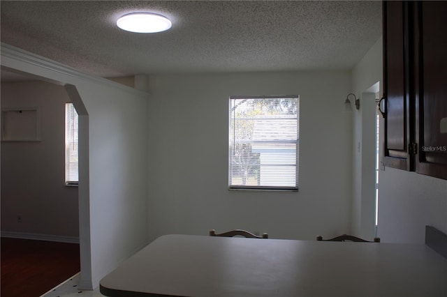 interior space featuring a textured ceiling and hardwood / wood-style flooring