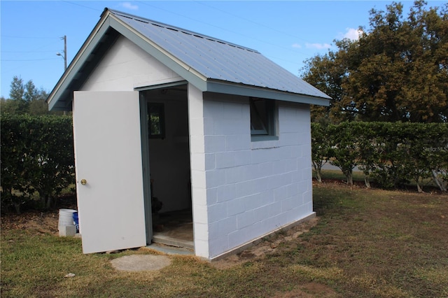 view of outbuilding with a lawn