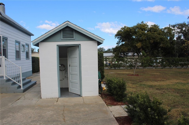 view of outbuilding featuring a yard