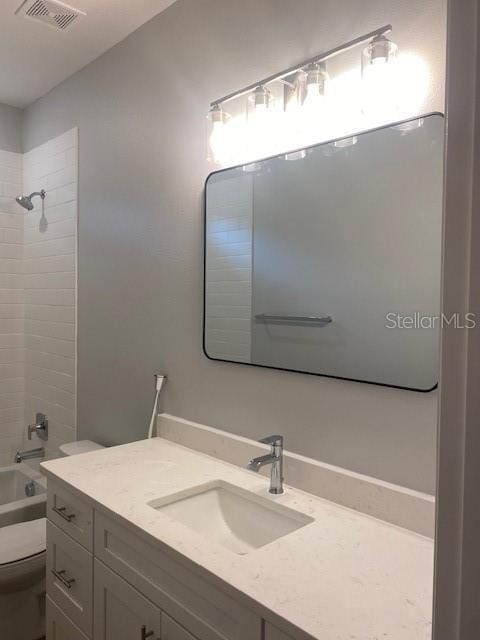 full bathroom featuring vanity, shower / bathtub combination, and toilet