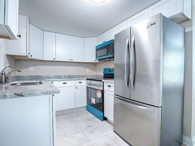 kitchen with white cabinetry, sink, and appliances with stainless steel finishes