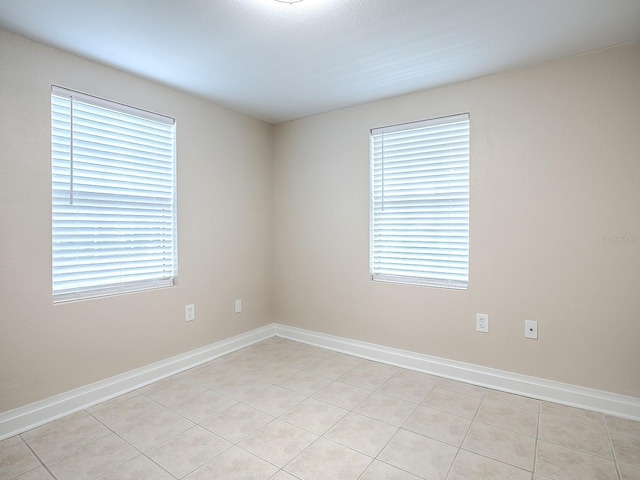 empty room with light tile patterned floors