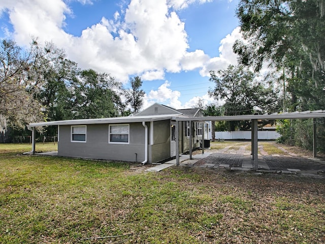 rear view of property with a yard