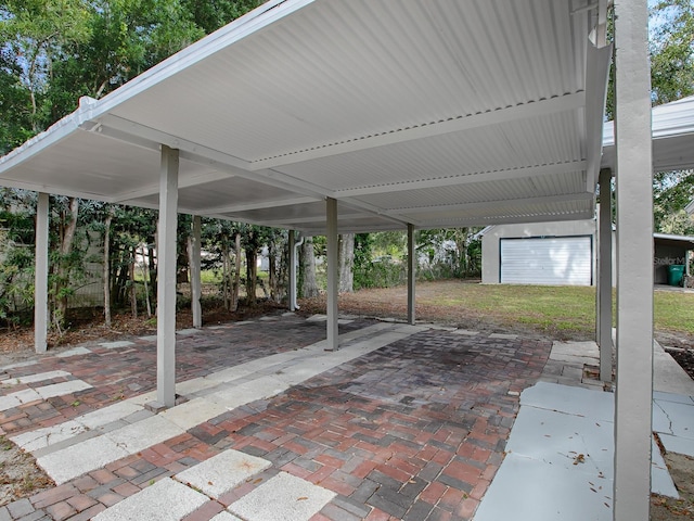 view of patio featuring a carport and an outbuilding