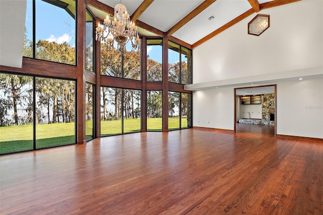 unfurnished living room featuring beamed ceiling, a notable chandelier, wood-type flooring, and high vaulted ceiling