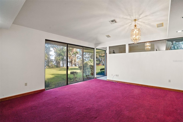 empty room featuring carpet and a notable chandelier