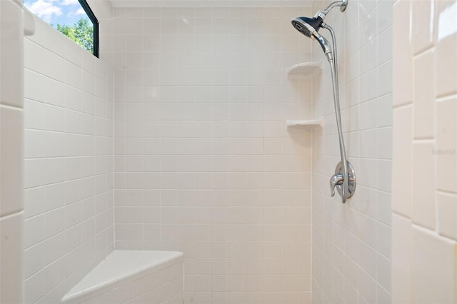 bathroom with tiled shower