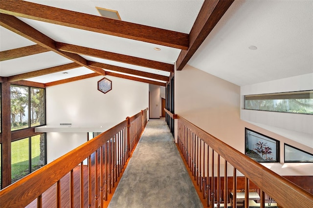 corridor with carpet and lofted ceiling with beams