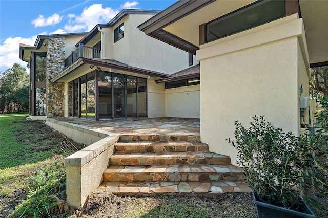 doorway to property featuring a patio area and a balcony