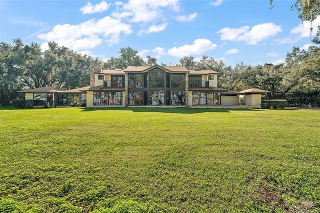 rear view of property with a yard