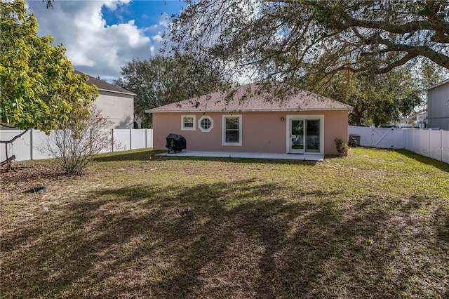 rear view of house with a patio area and a yard