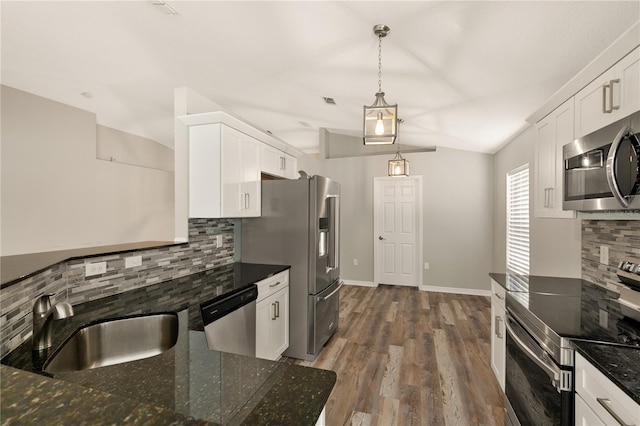 kitchen featuring decorative backsplash, stainless steel appliances, dark wood-type flooring, decorative light fixtures, and white cabinetry