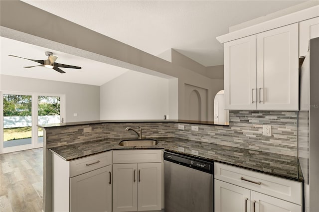 kitchen with dark stone countertops, white cabinetry, sink, and appliances with stainless steel finishes