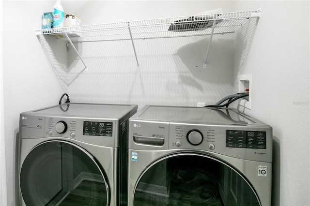 clothes washing area with independent washer and dryer