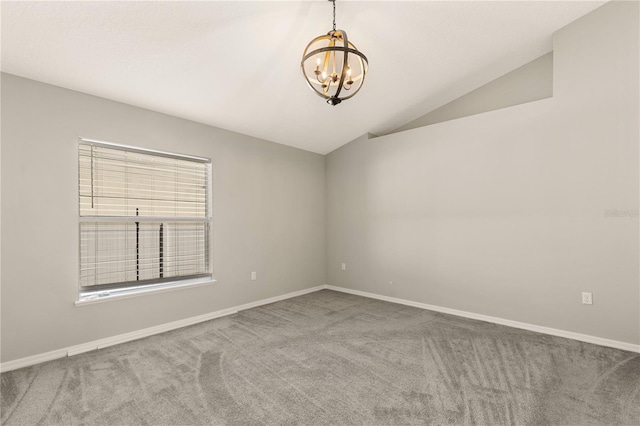 carpeted empty room with a notable chandelier and lofted ceiling