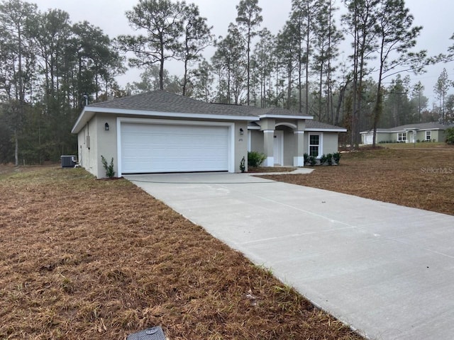 ranch-style home with cooling unit and a garage