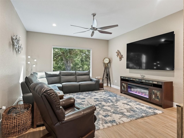 living room with ceiling fan and light hardwood / wood-style floors