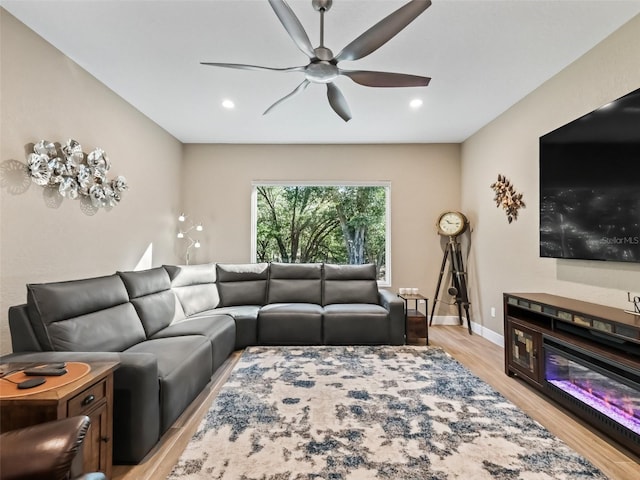 living room featuring ceiling fan and light hardwood / wood-style flooring