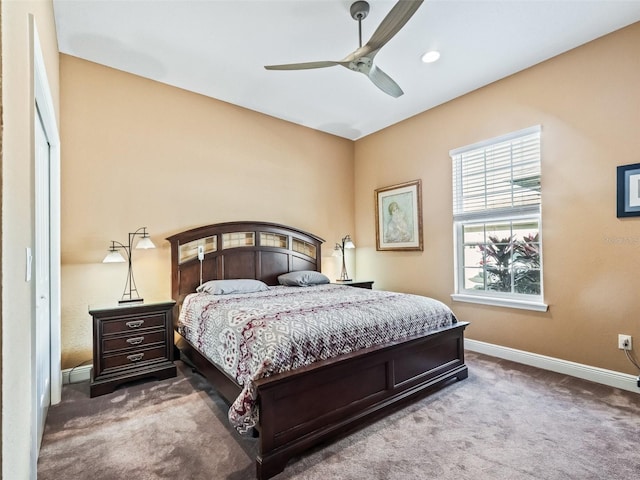 carpeted bedroom featuring ceiling fan and a closet