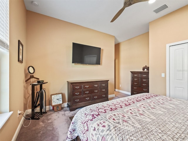 carpeted bedroom featuring ceiling fan and a closet