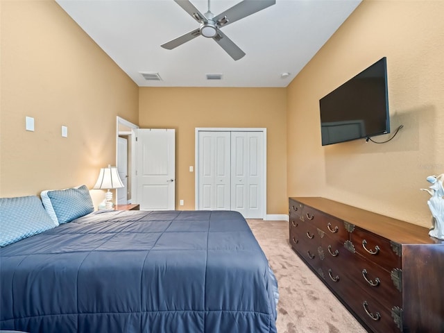 bedroom with ceiling fan, a closet, and light colored carpet