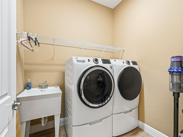 laundry area featuring washer and dryer and sink