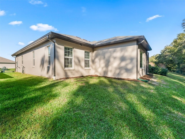 back of house with a lawn