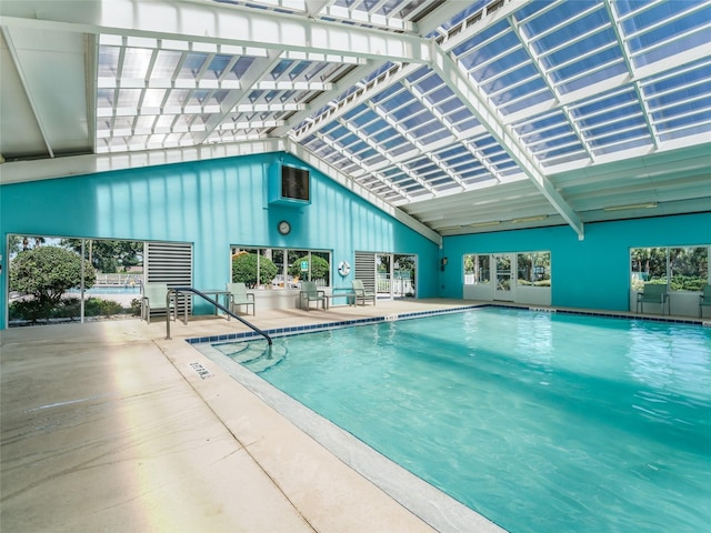 view of pool featuring an outdoor kitchen, a lanai, and a patio area