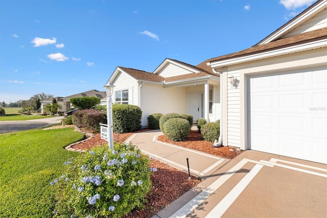 single story home featuring a front yard and a garage