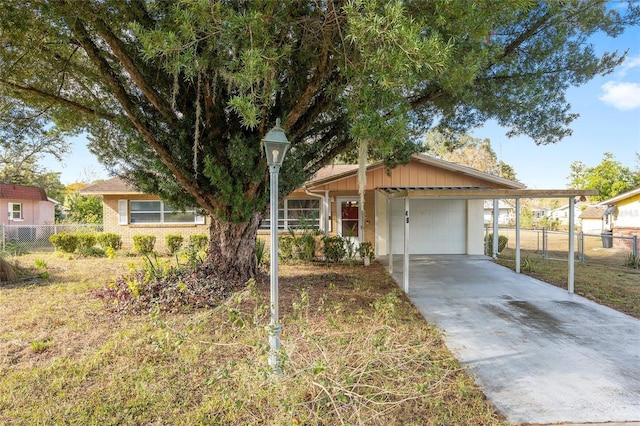 ranch-style home with a front yard, a garage, and a carport