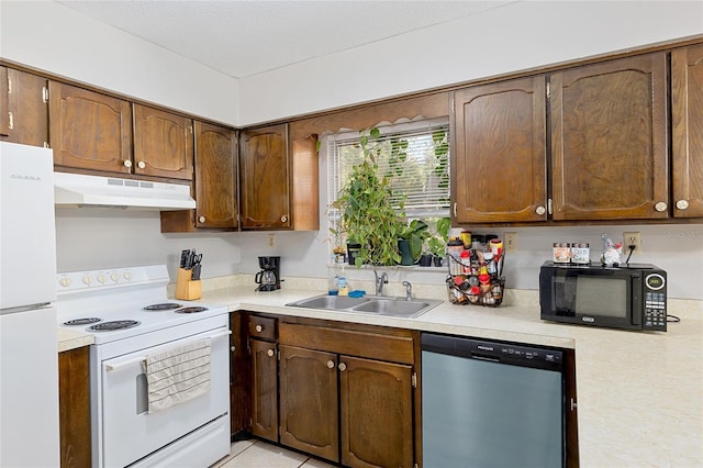 kitchen featuring a textured ceiling, sink, and white appliances