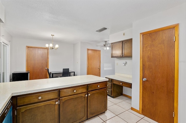 kitchen featuring ceiling fan with notable chandelier, hanging light fixtures, light tile patterned floors, a textured ceiling, and dishwashing machine