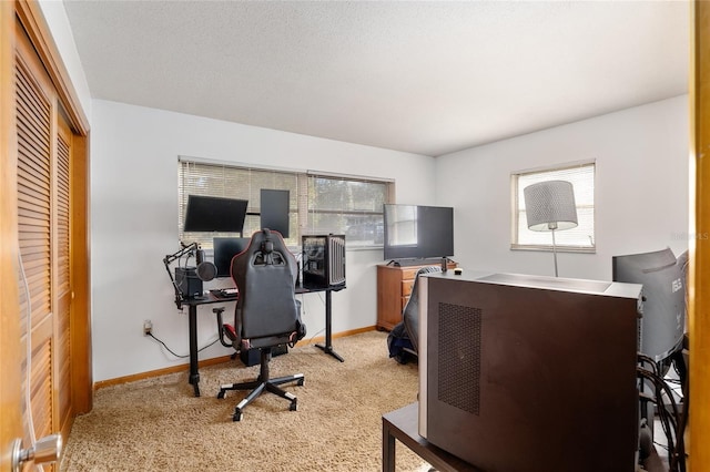 office area featuring light carpet and a textured ceiling