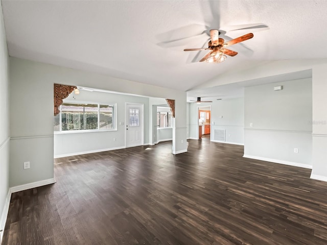 unfurnished living room featuring vaulted ceiling, ceiling fan, a textured ceiling, and dark hardwood / wood-style floors